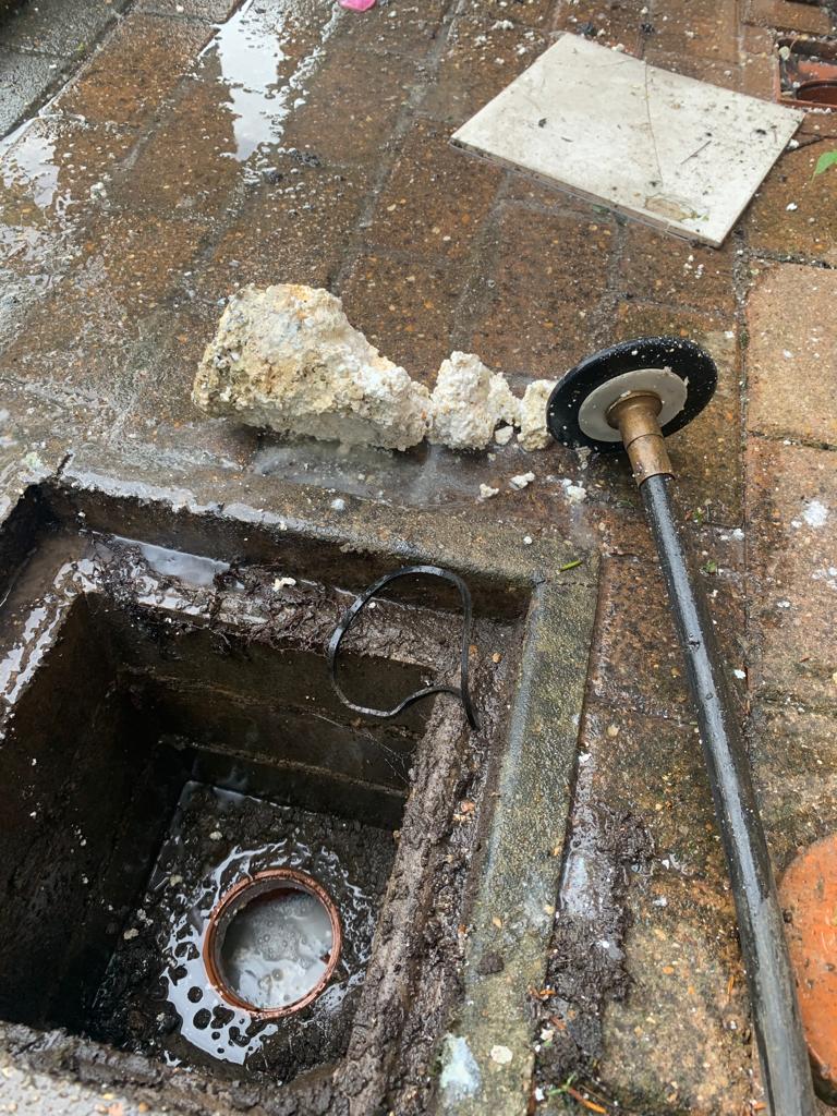 A blocked drain being cleared